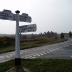 An old-style road sign showing the way to Forest Row and other towns.